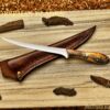 Handcrafted camel bone steel collectible with engraved fisherman handle and leather sheath
